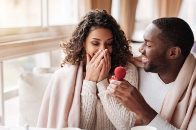 Man on knee proposing to future wife