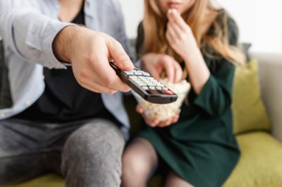 Adult Couple Watching Television Together