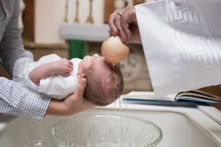 A baby getting baptized
