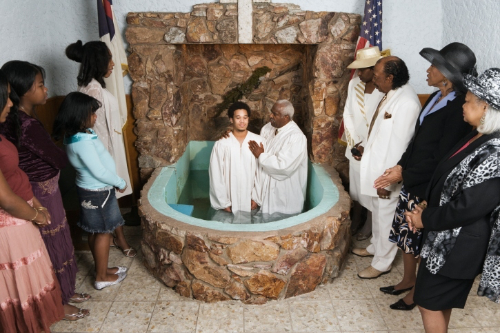 A young man being baptized