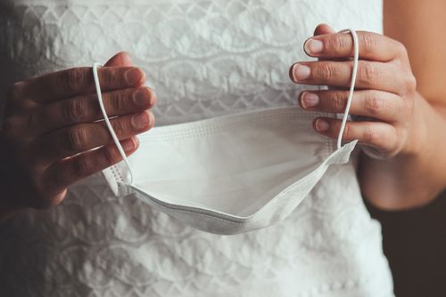 Bride Holding a Face Mask