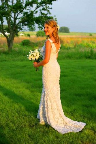 Young woman poses in beautiful wedding dress