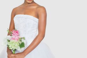 Bride holding bouquet in wedding dress