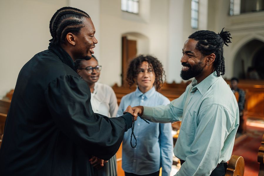 two members of a group shaking hangs