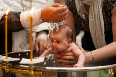 A baby getting baptised