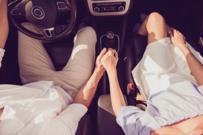 Couple Holding Hands in a Car