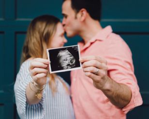 Couple Holding Ultrasound Photo Together