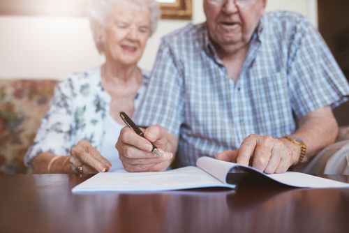 Elderly Couple Filling Out Paperwork