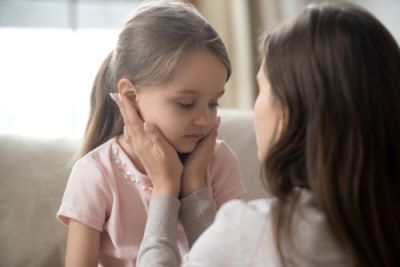 hands on child's cheeks