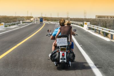 Just Married Couple Riding Away on a Motorcycle