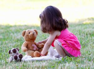 Little Girl Plays with Stuffed Animal