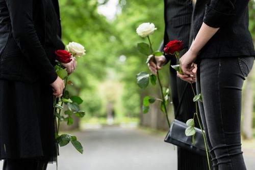Mourners Holding Flowers