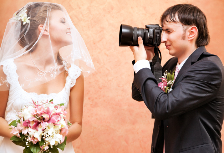 Wedding photographer taking picture of the bride