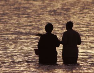 Ordained minister performing a baptism