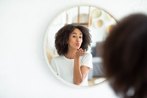 Woman Blowing a Kiss in the Mirror