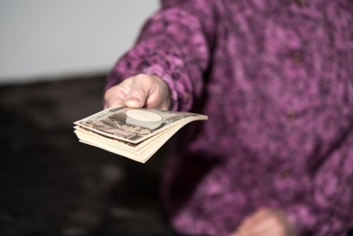 Woman Handing Over Money
