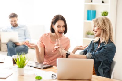 Woman Showing Engagement Ring to Coworker