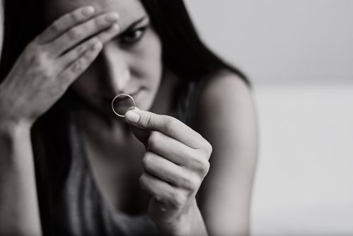 Woman Staring at Her Wedding Ring