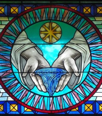 Stained glass window depicting a baptism