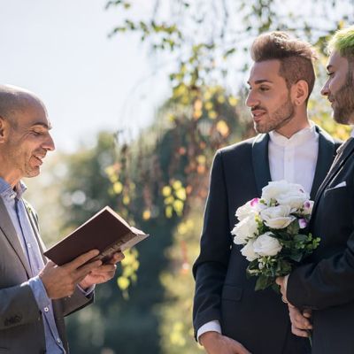 Wedding officiant delivering speech at wedding ceremony