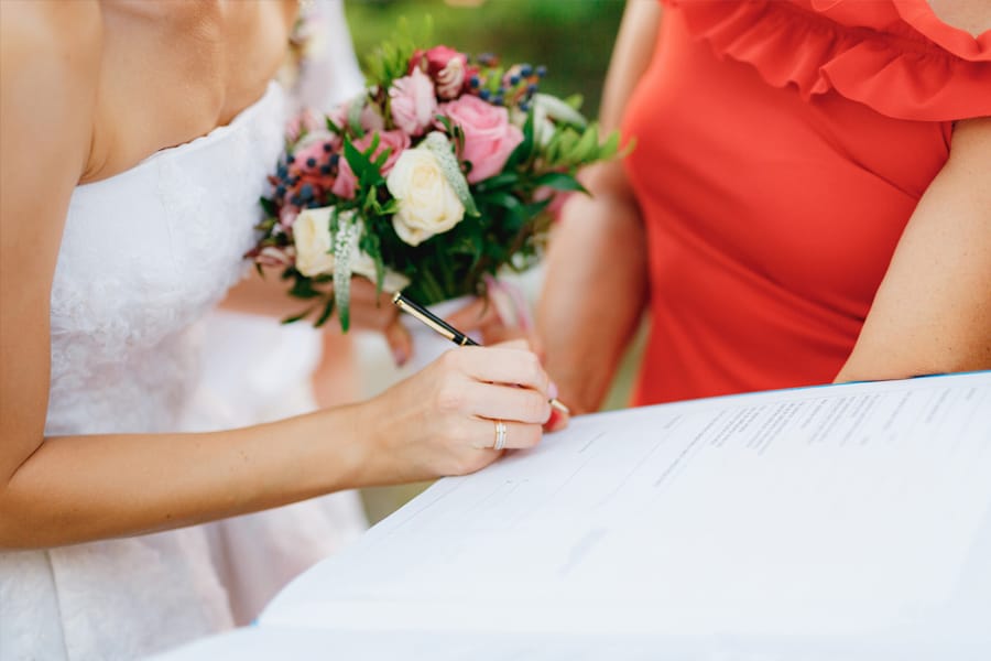 Bride signing marriage license after civil wedding