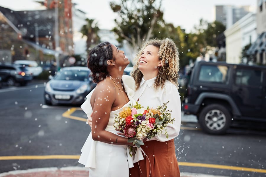 Newlywed brides embracing after humanist wedding ceremony