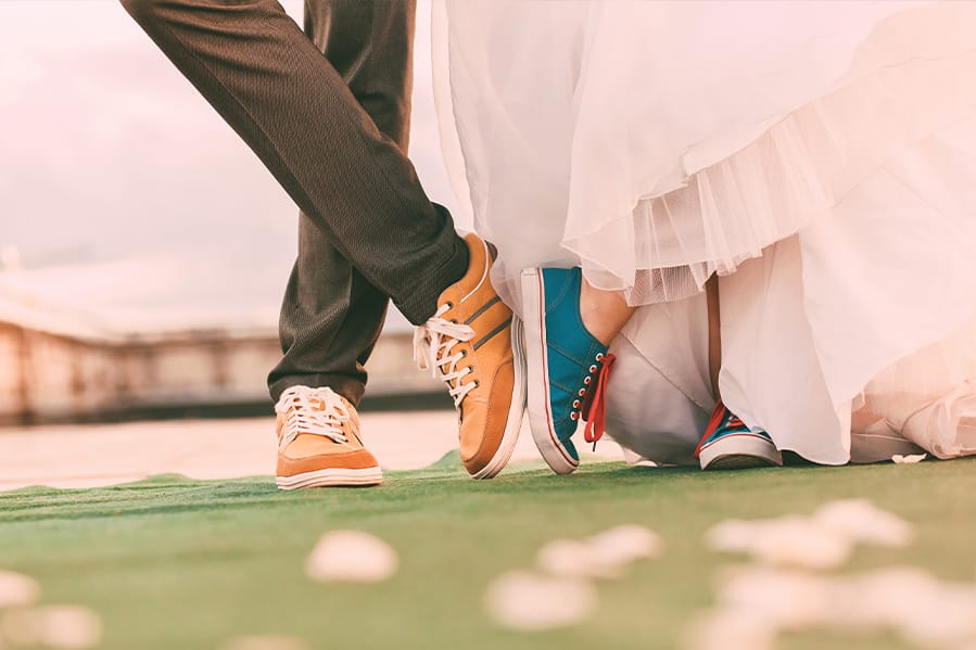 Wedding couple wearing non-traditional wedding shoes. 