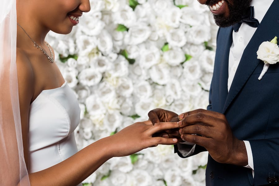 Happy bride and groom during wedding ceremony ring exchange
