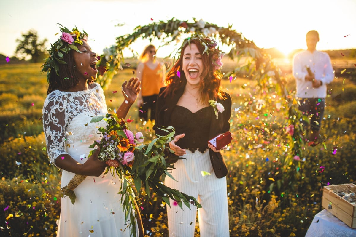 Happy brides laughing after unique wedding ceremony